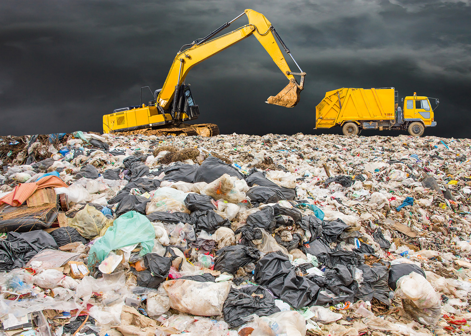 garbage dump pile in trash dump or landfill,backhoe and truck is