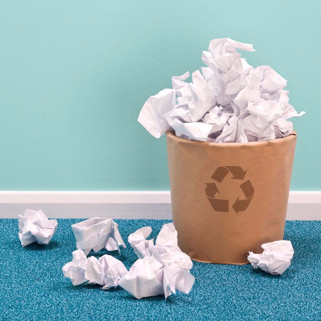 Recycle waste paper basket on office floor